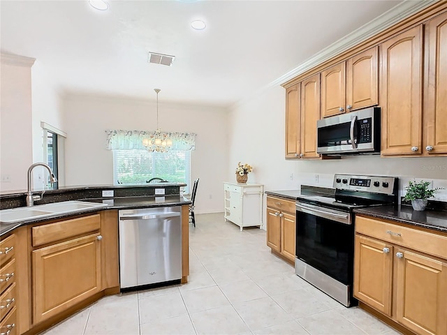 kitchen with hanging light fixtures, light tile patterned floors, stainless steel appliances, sink, and a notable chandelier