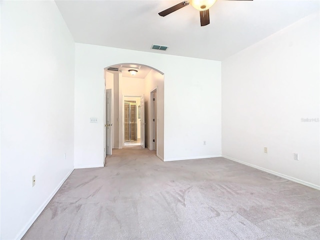 carpeted spare room featuring ceiling fan