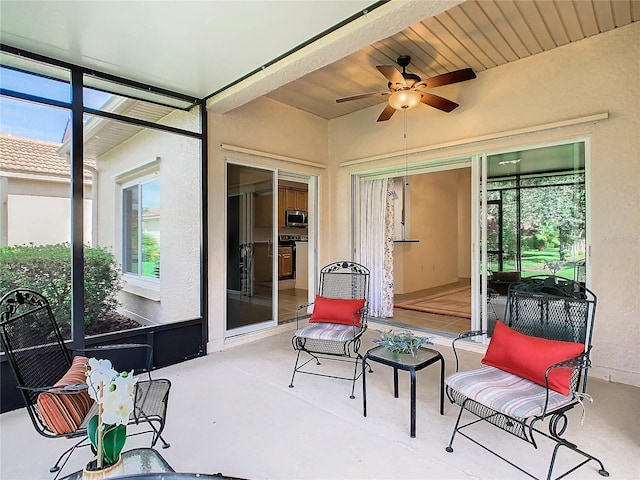 sunroom / solarium with wooden ceiling and ceiling fan