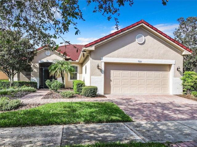 mediterranean / spanish-style house with a garage