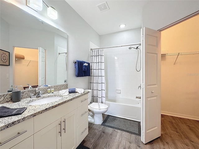 full bathroom with vanity, toilet, wood-type flooring, and shower / bath combo with shower curtain