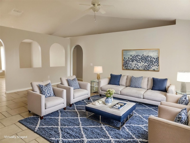 living room with tile patterned flooring, ceiling fan, and vaulted ceiling