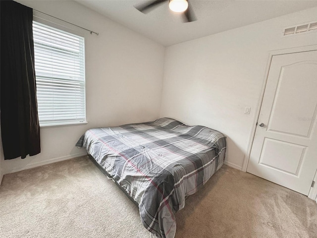 carpeted bedroom with ceiling fan