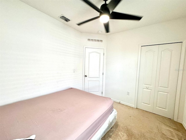 unfurnished bedroom featuring light carpet and ceiling fan