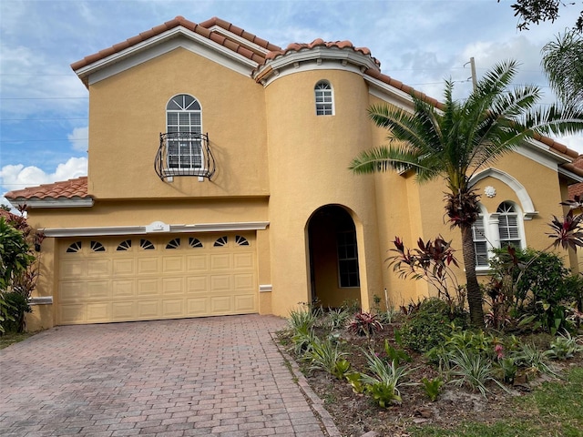 11774 Via Lucerna Cir, Windermere, FL 34786 - mediterranean / spanish house featuring stucco siding, a tiled roof, decorative driveway, and a garage