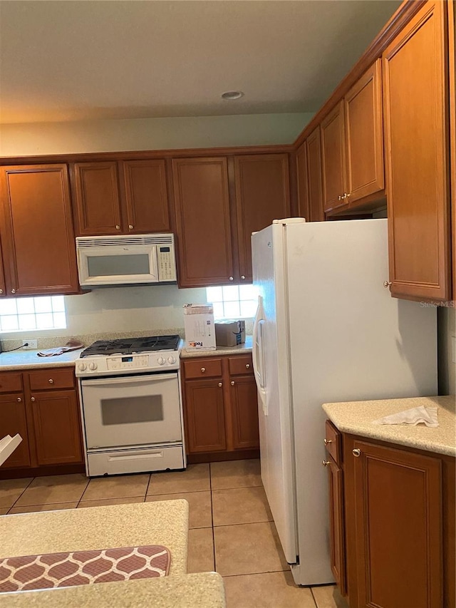 kitchen featuring white appliances and light tile patterned floors