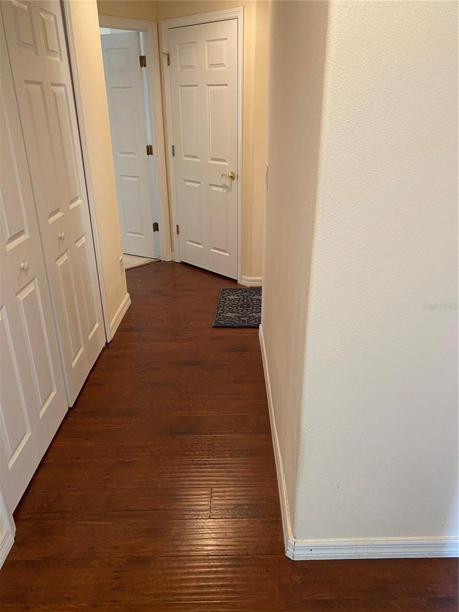 corridor featuring dark wood-type flooring