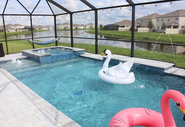 view of swimming pool with an in ground hot tub, pool water feature, a water view, and glass enclosure