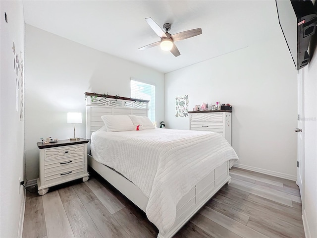 bedroom featuring light wood-type flooring and ceiling fan