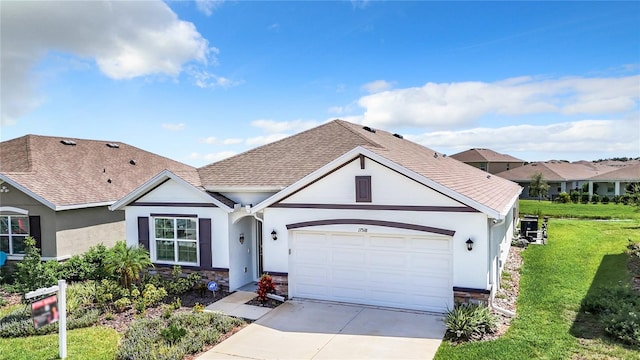 view of front of house featuring a front yard and a garage