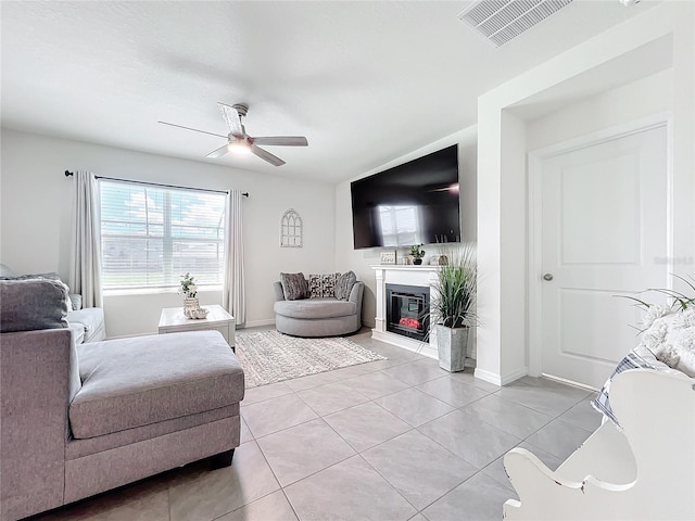 living room featuring ceiling fan and light tile patterned flooring