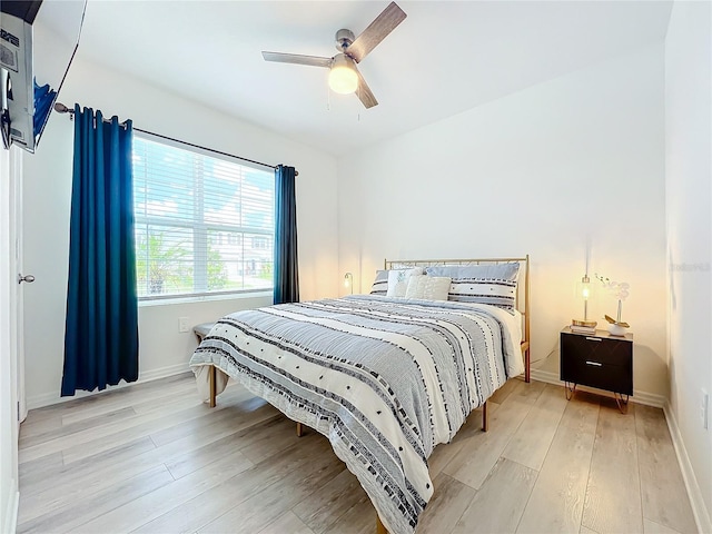 bedroom with wood-type flooring and ceiling fan