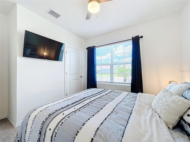 bedroom featuring light hardwood / wood-style floors and ceiling fan