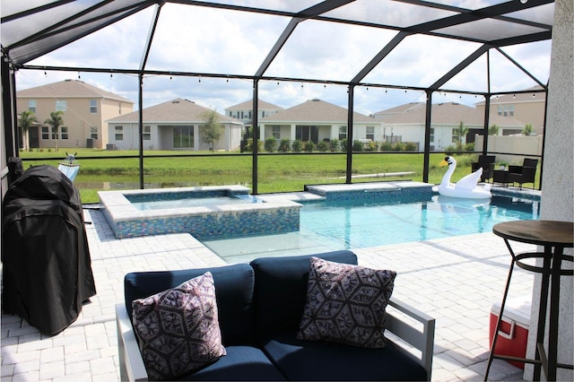 view of pool featuring a yard, an in ground hot tub, glass enclosure, and a patio area