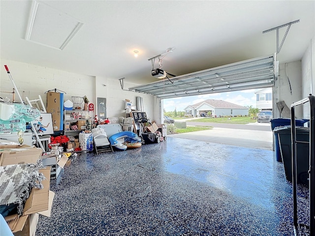 garage featuring a garage door opener, electric panel, and a carport