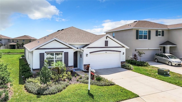 view of front of home featuring a front yard and a garage