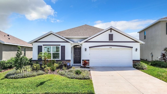 view of front of property with an attached garage, stone siding, stucco siding, a front yard, and driveway