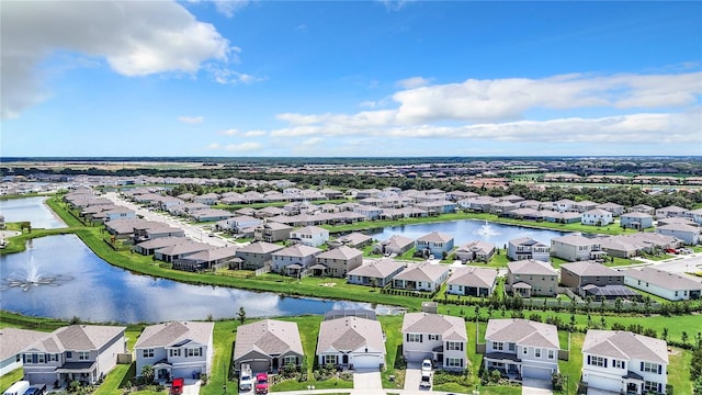 drone / aerial view featuring a water view and a residential view