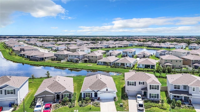 birds eye view of property with a water view and a residential view