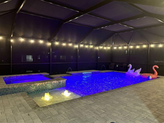 view of pool with a patio area and a pool with connected hot tub