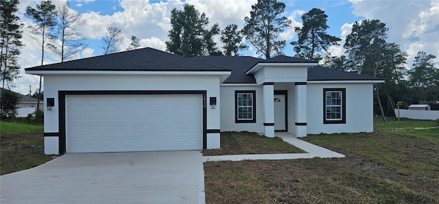 view of front of house with a garage and a front lawn