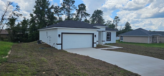 view of front facade with a garage, a front lawn, and central AC