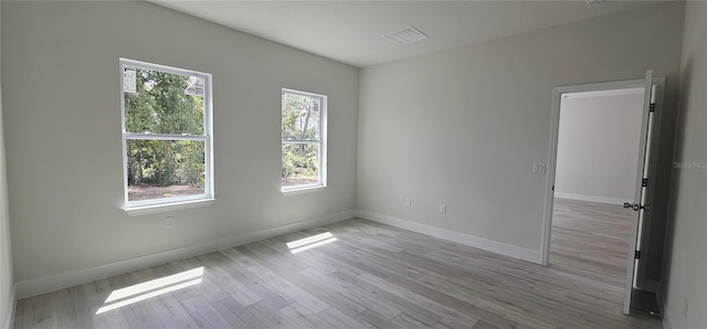 empty room featuring light wood-type flooring and a wealth of natural light