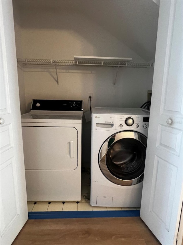 laundry room featuring washer and dryer and tile patterned floors