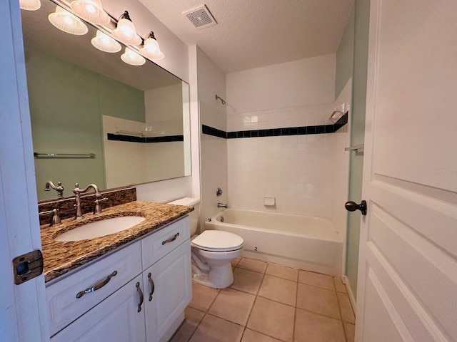 full bathroom featuring toilet, tile patterned floors, vanity, a textured ceiling, and tiled shower / bath combo