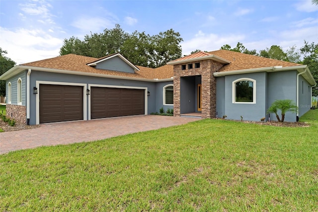 view of front of property with a garage and a front lawn