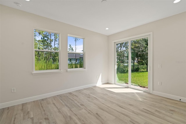 empty room featuring light hardwood / wood-style flooring and a healthy amount of sunlight