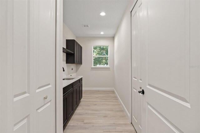 kitchen with light hardwood / wood-style floors and sink