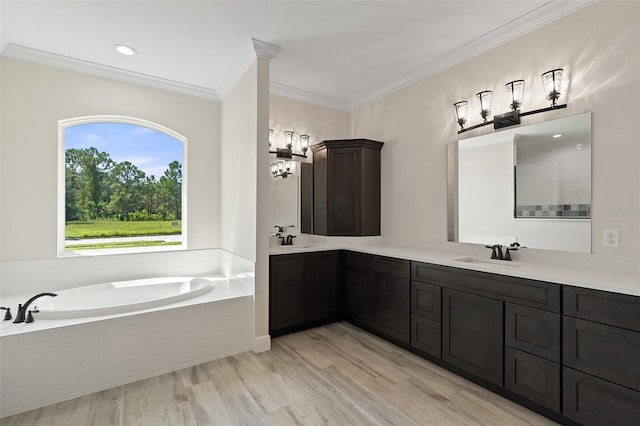 bathroom featuring crown molding, wood-type flooring, tiled bath, and vanity