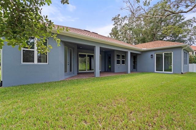 rear view of house with a yard