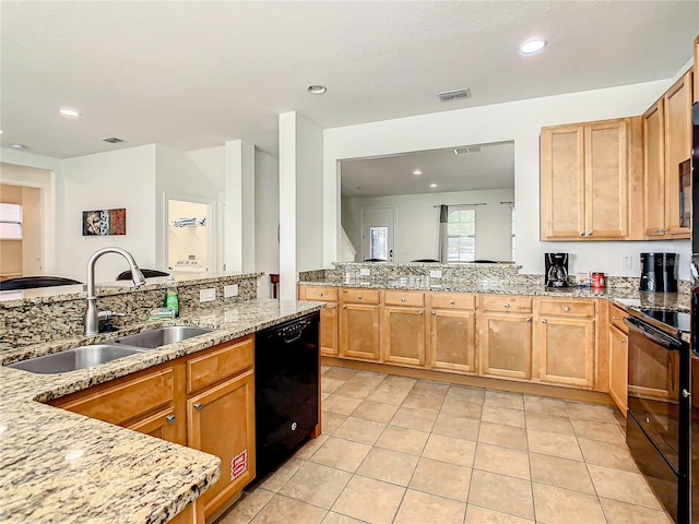 kitchen featuring light tile patterned floors, light stone countertops, sink, black appliances, and light brown cabinets