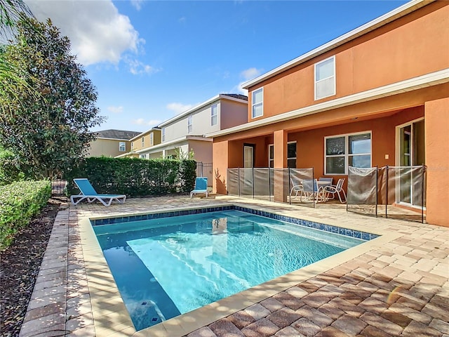 view of swimming pool featuring a patio area