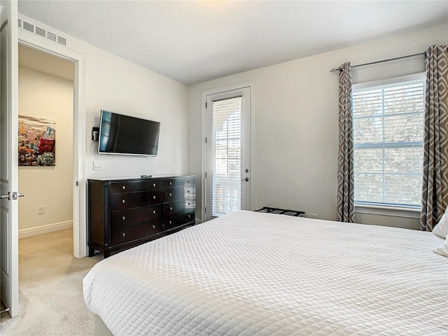 bedroom with light carpet and access to outside