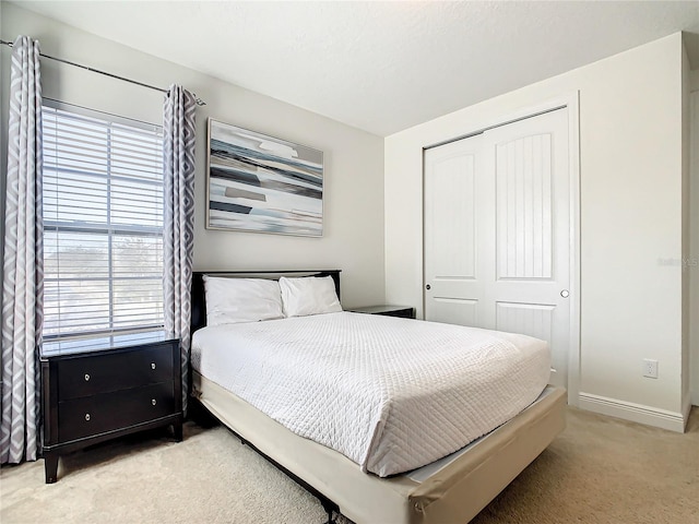 carpeted bedroom featuring a closet