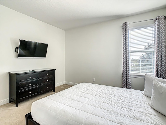 bedroom with light colored carpet