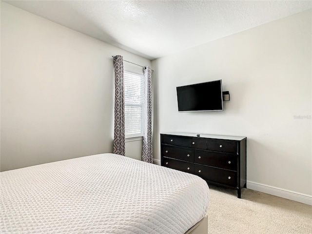 carpeted bedroom with a textured ceiling