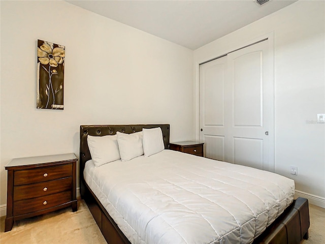 carpeted bedroom with a closet