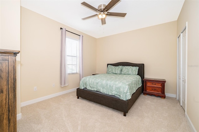 bedroom with ceiling fan and light carpet