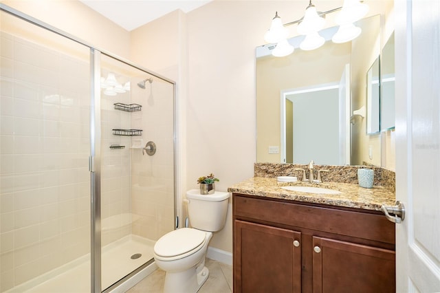 bathroom with vanity, toilet, tile patterned floors, and a shower with shower door