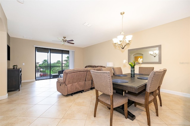 dining space featuring ceiling fan with notable chandelier and light tile patterned flooring