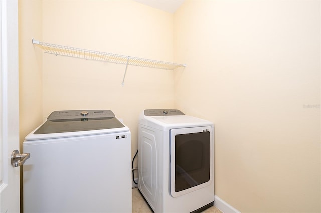 clothes washing area with washer and clothes dryer