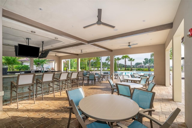 view of patio featuring a bar and ceiling fan