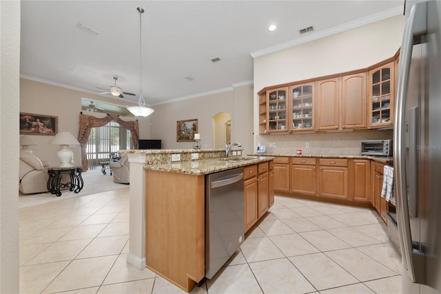 kitchen featuring hanging light fixtures, stainless steel appliances, ornamental molding, sink, and ceiling fan