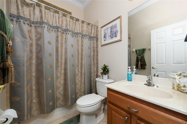 bathroom with tile patterned floors, toilet, ornamental molding, and vanity