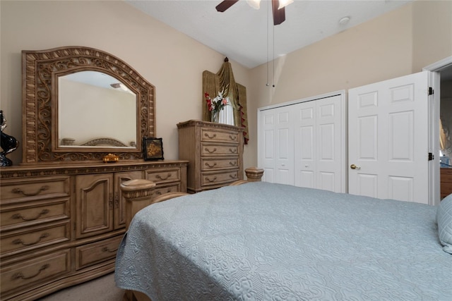 bedroom featuring vaulted ceiling, a closet, ceiling fan, and carpet floors