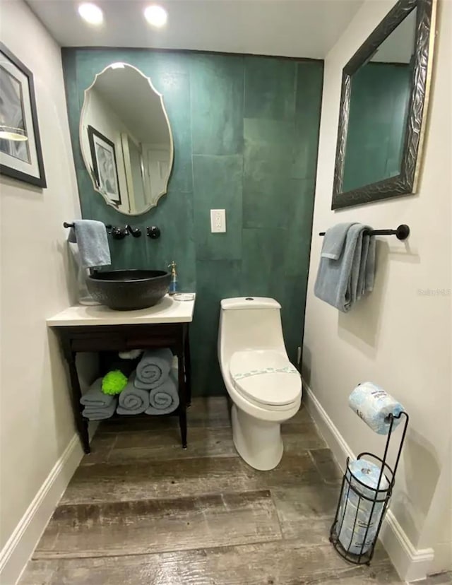 bathroom with vanity, toilet, and hardwood / wood-style flooring